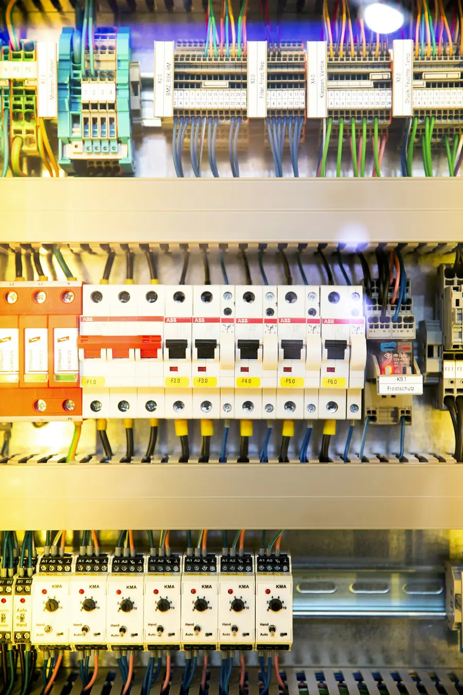 Rows of circuit breakers inside an open electrical panel