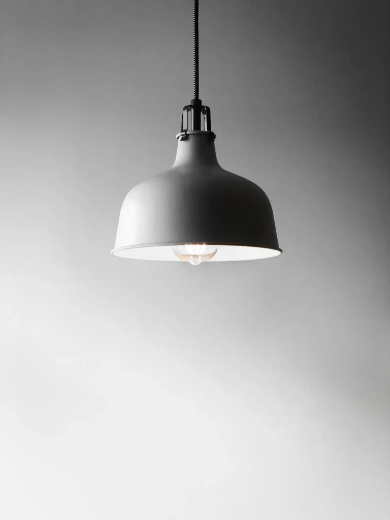 Pendant light fixture hanging against a white wall